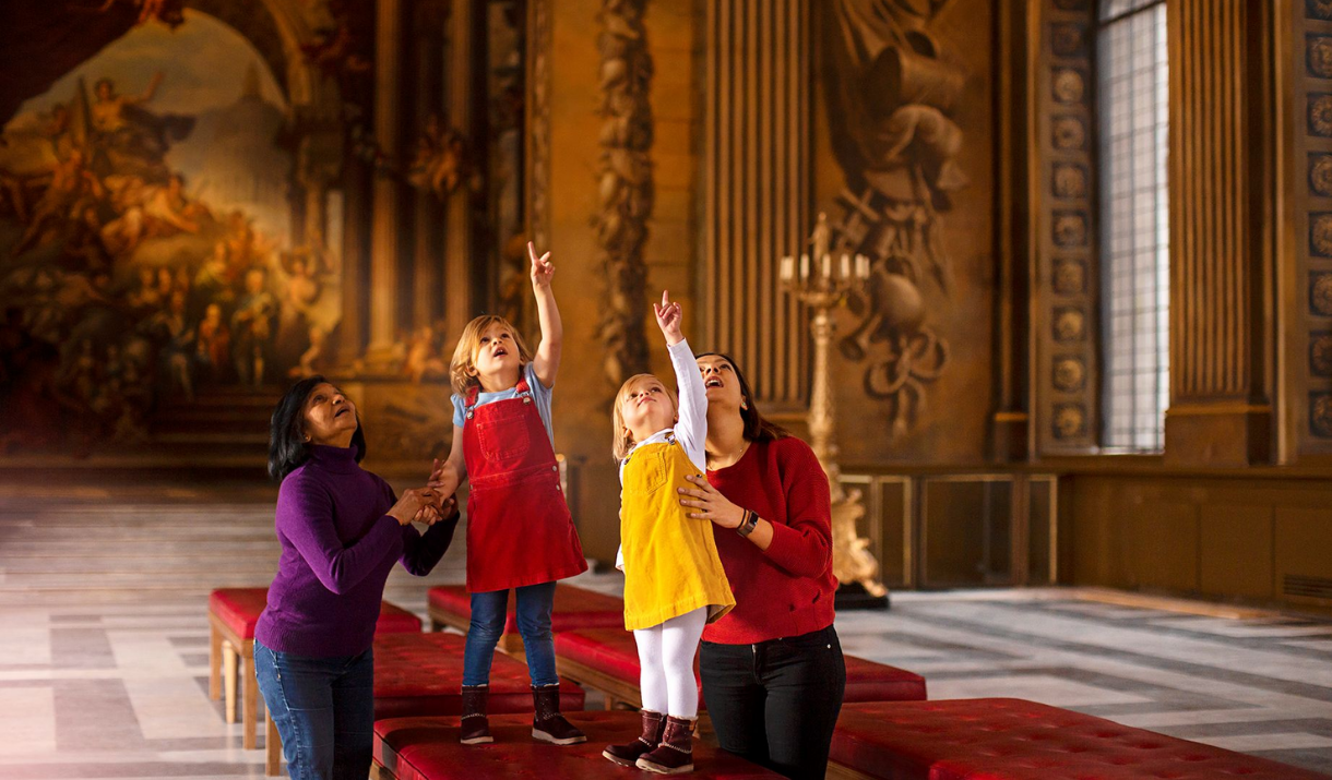 A family point up at the ceiling in the Painted Hall at the Old Royal Naval College in Greenwich